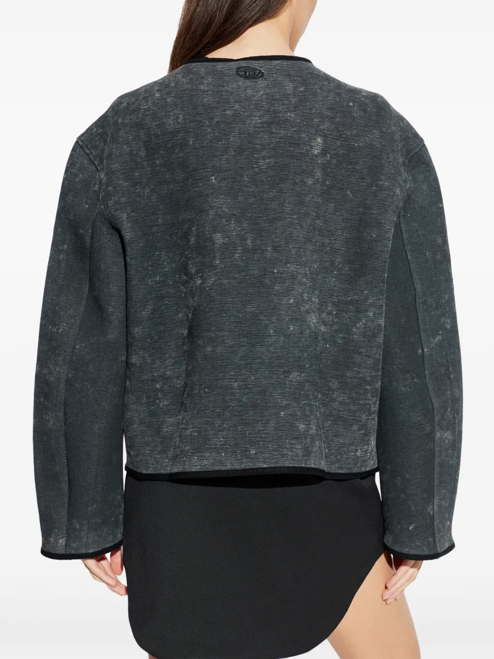 grey jacket worn by a person, showing the jacket fit