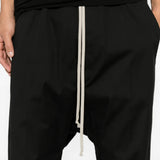 Black pants worn by a person, showing the pants fit