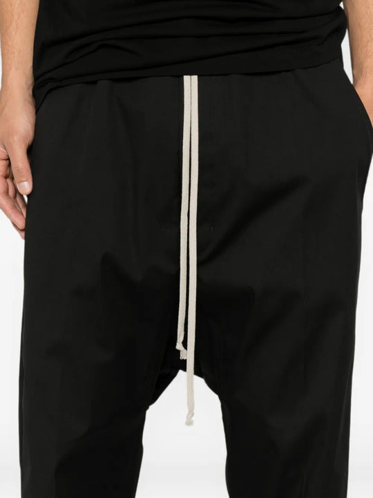 Black pants worn by a person, showing the pants fit