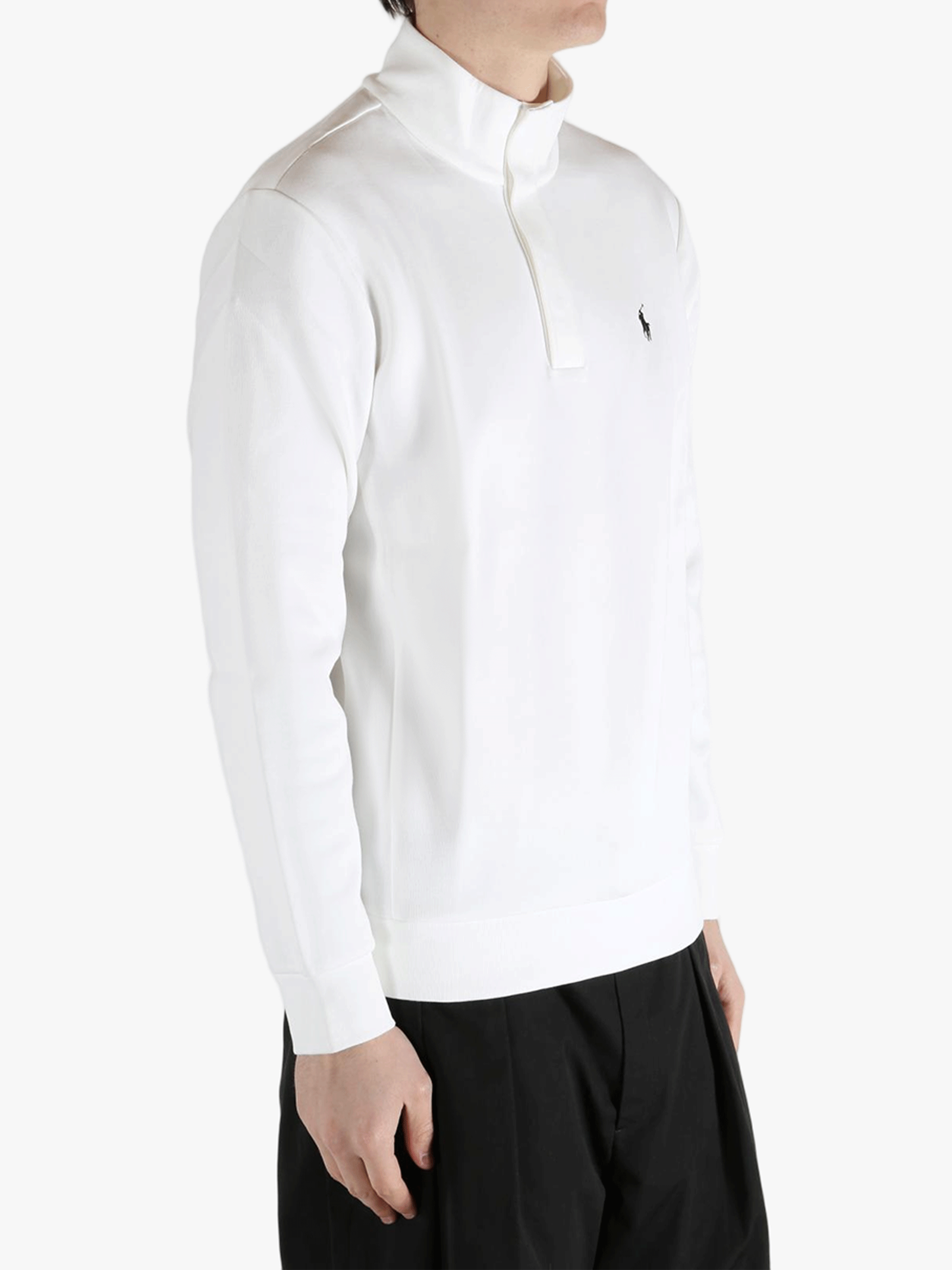 White pullover worn by a person, showing the pullover's fit