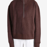 Brown hoodie worn by a person, showing the hoodie fit