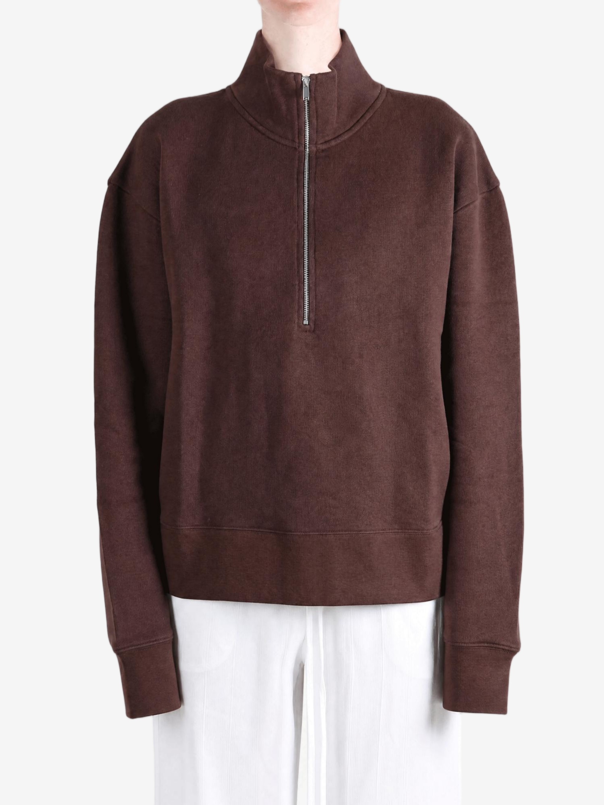 Brown hoodie worn by a person, showing the hoodie fit