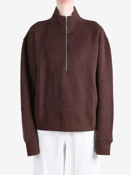 Brown hoodie worn by a person, showing the hoodie fit