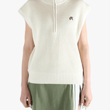 White vest worn by a person, showing the loose fit.