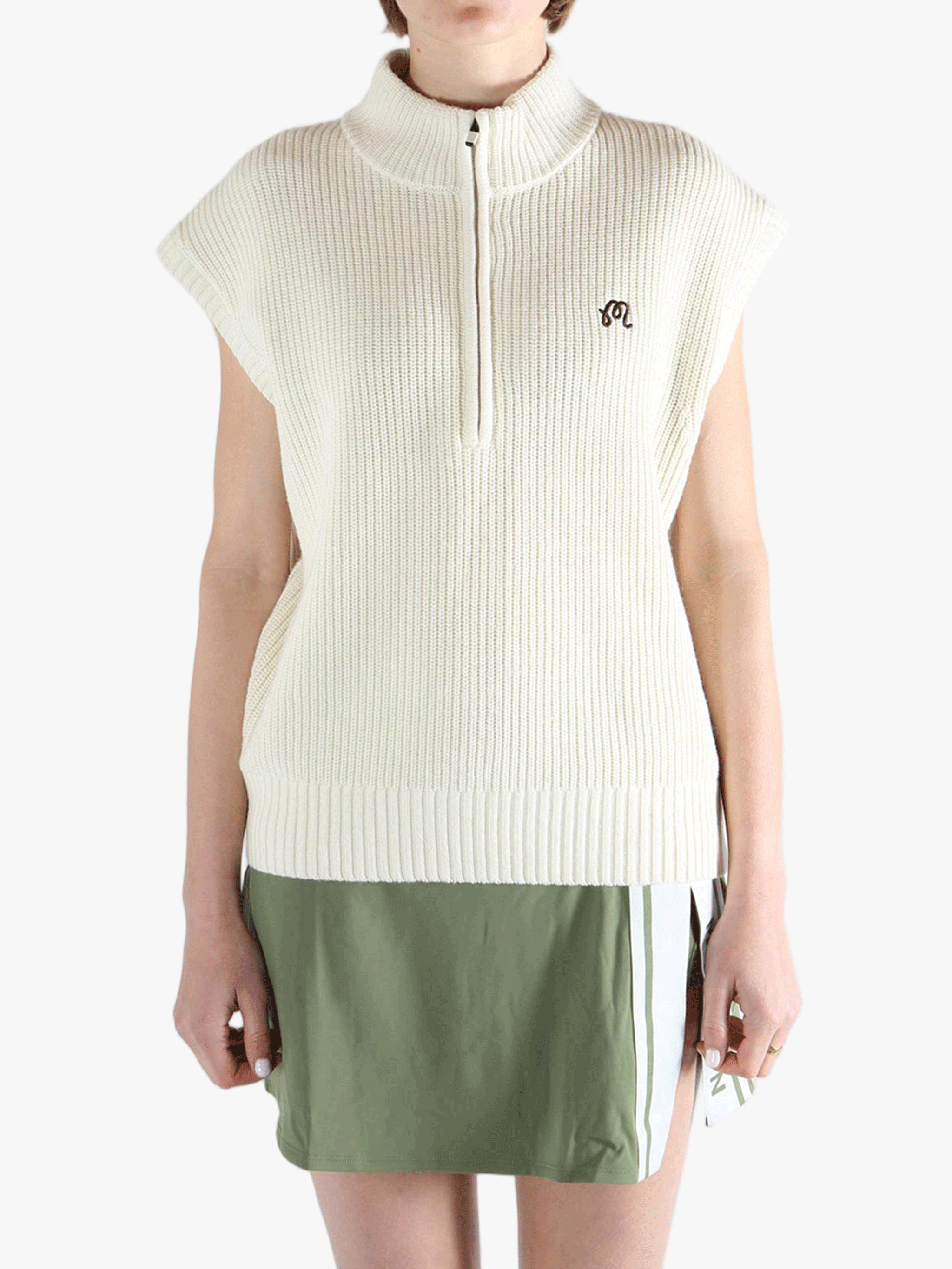 White vest worn by a person, showing the loose fit.