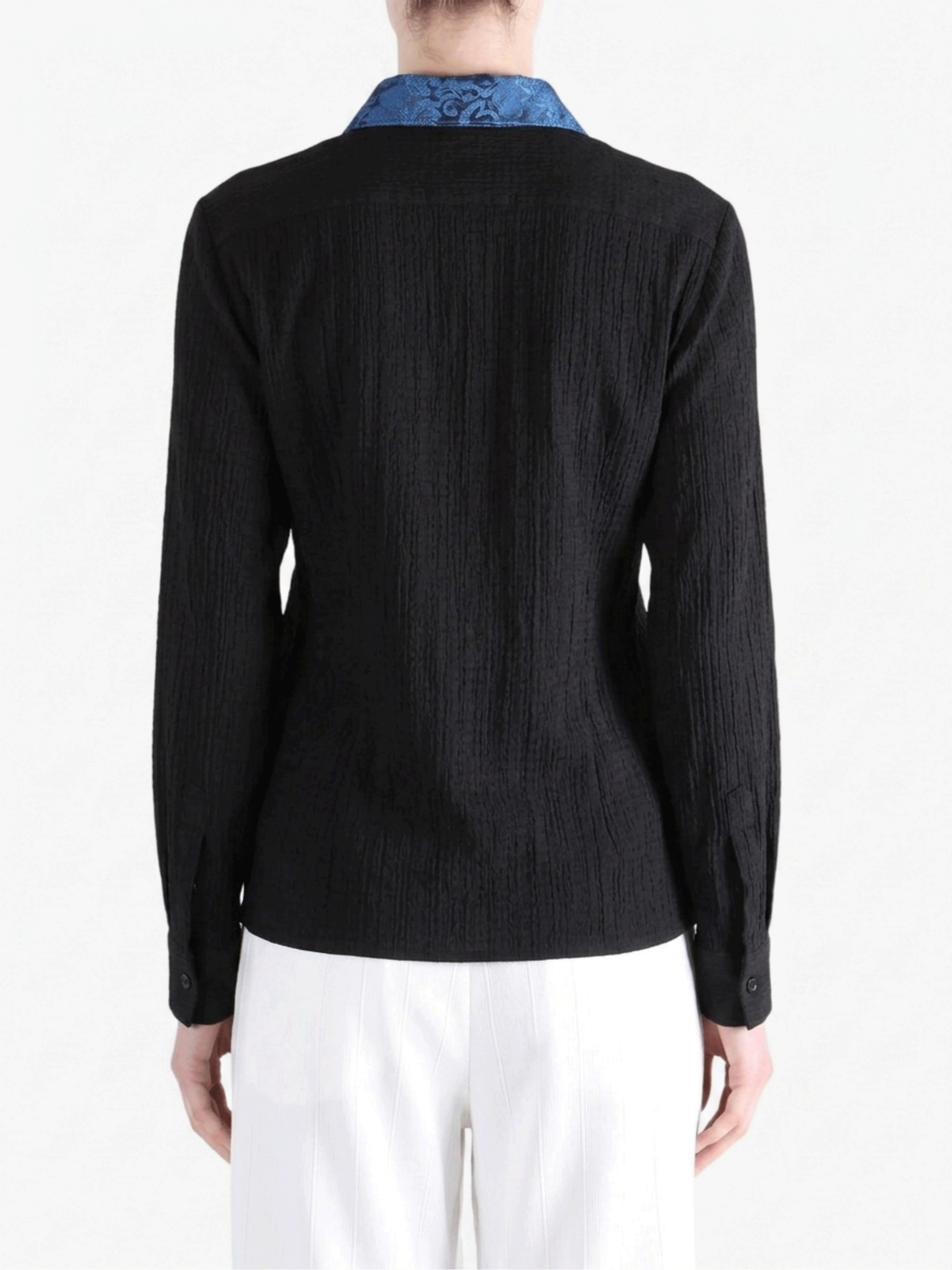 Black shirt worn by a person, showing the shirt fit