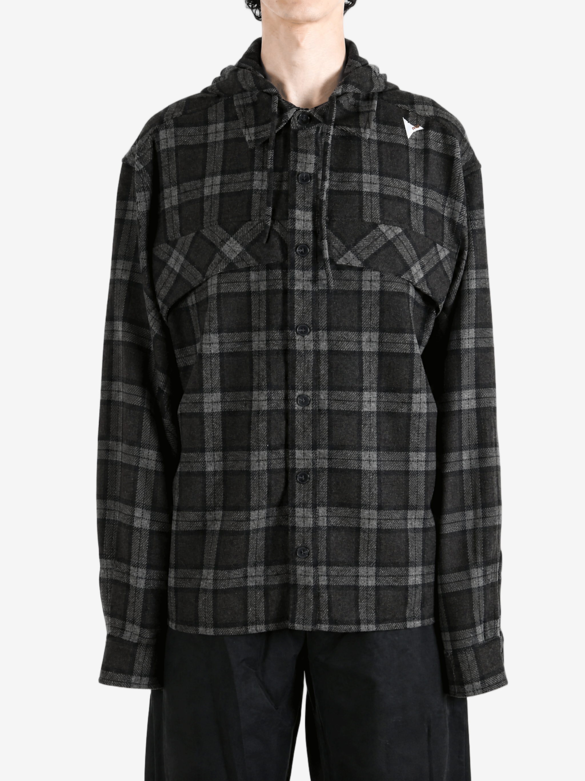 Black shirt worn by a person, showing the shirt fit