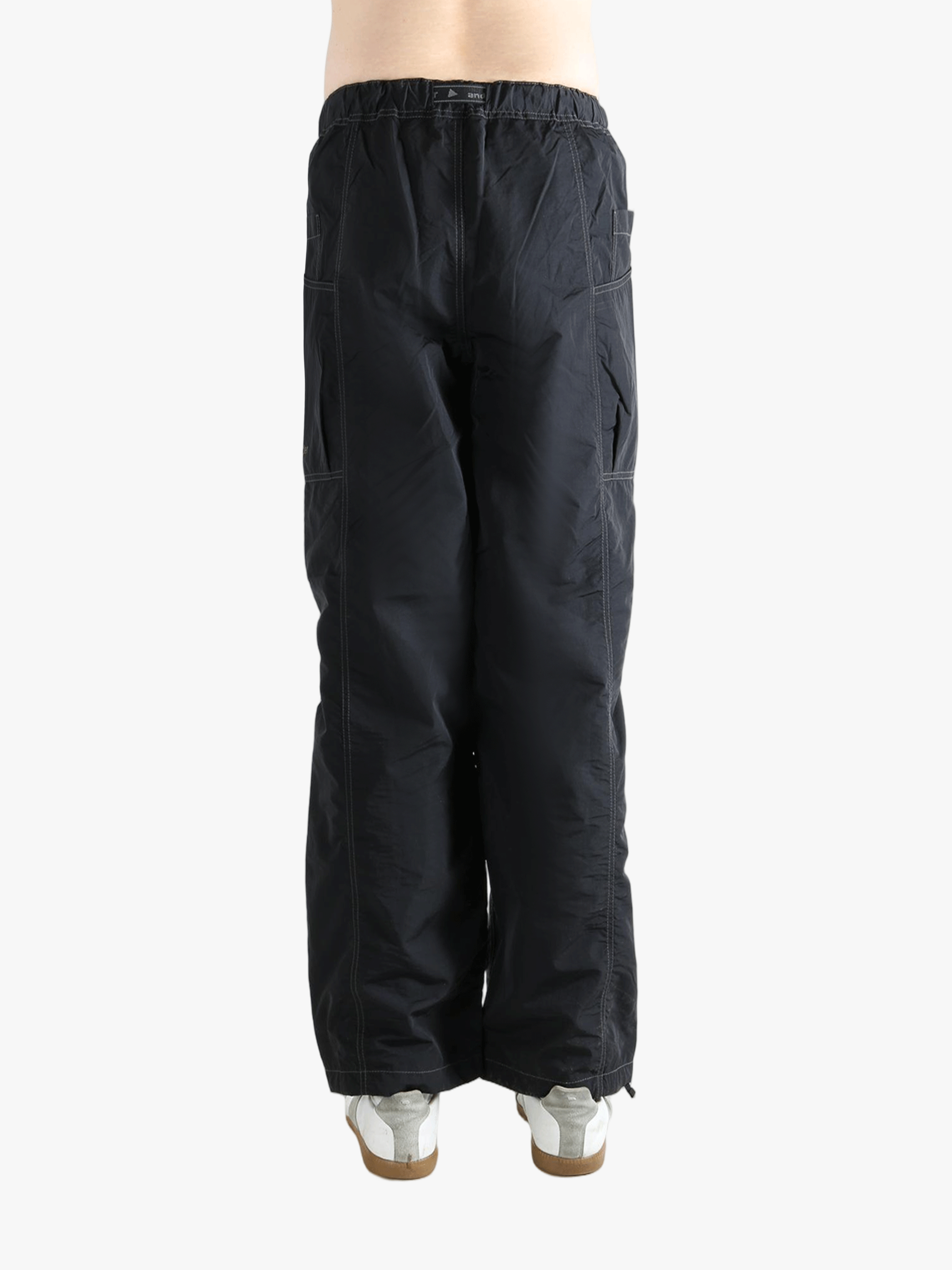 Black pants worn by a person, showing the pants fit