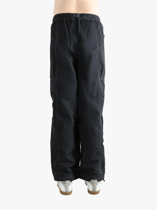 Black pants worn by a person, showing the pants fit