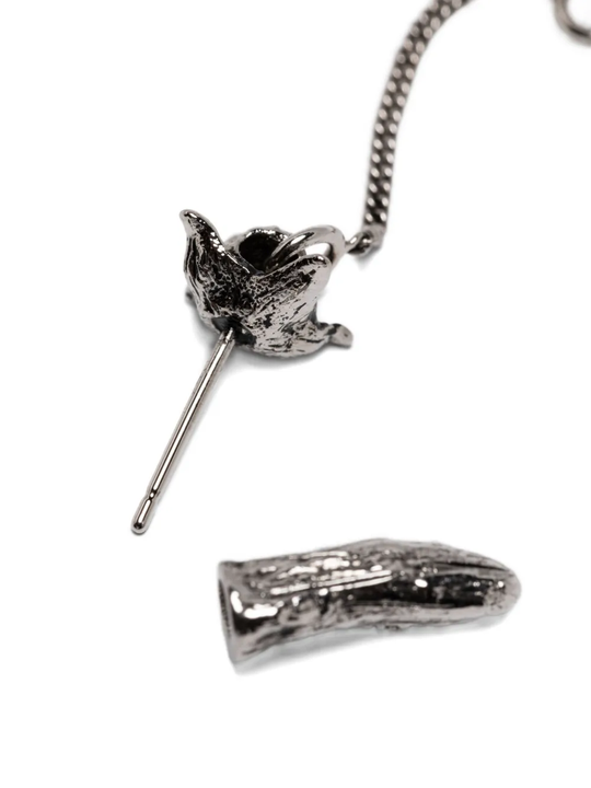 close up of grey jewelry, showing texture of the brass fabric