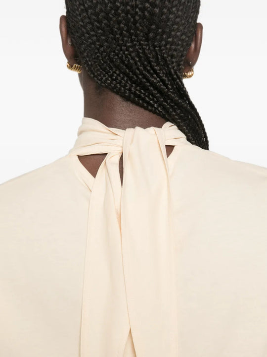 Tan top worn by a person, showing the top fit
