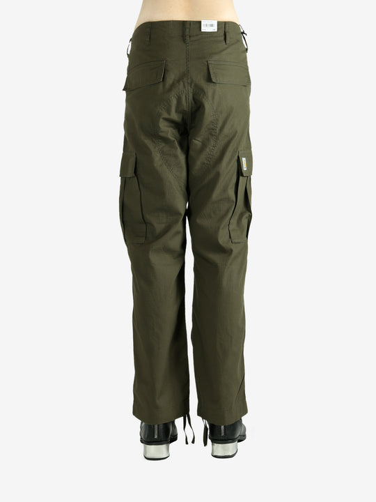 Green pants worn by a person, showing the pants's fit