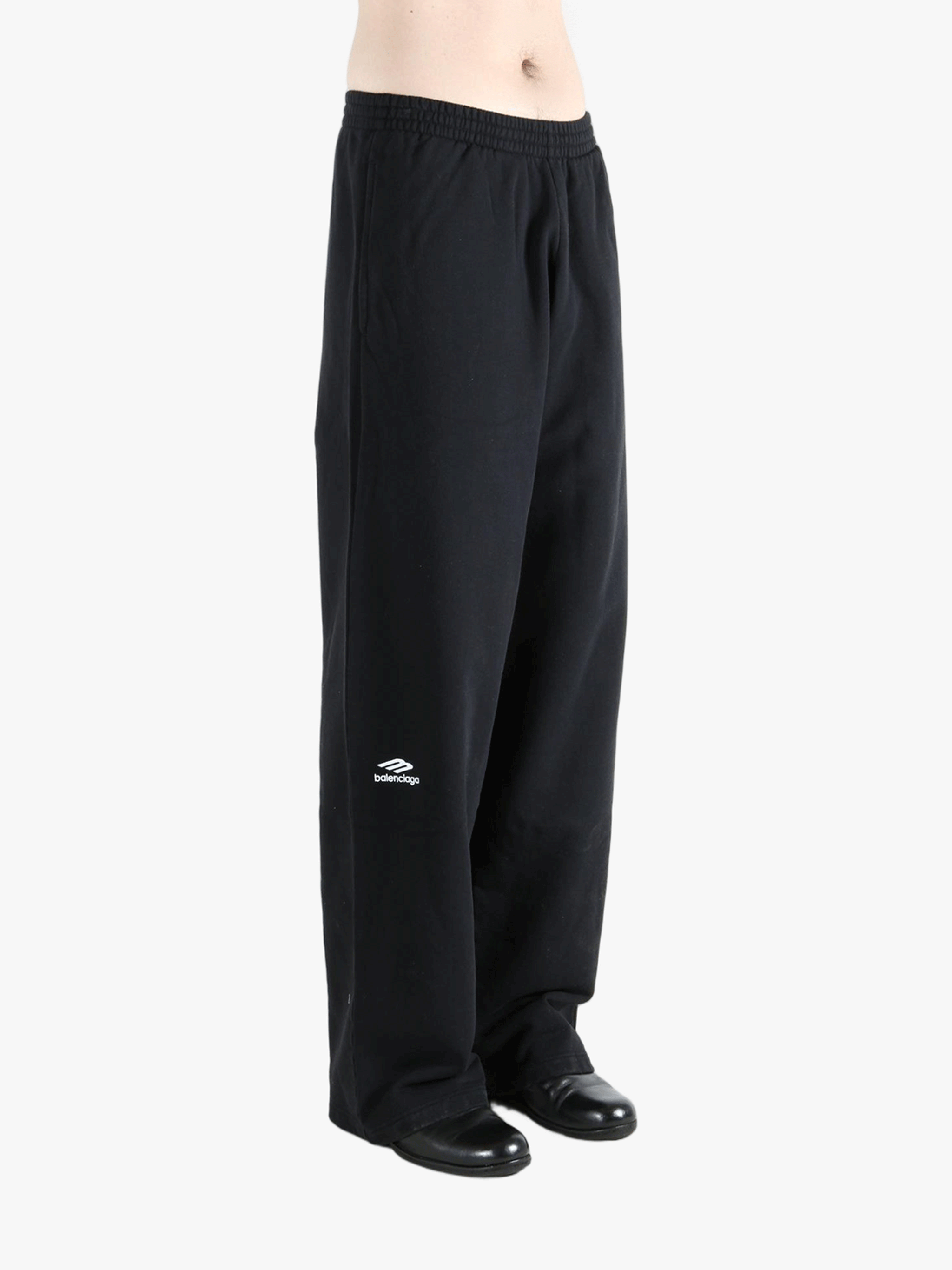 Black pants worn by a person, showing the pants fit