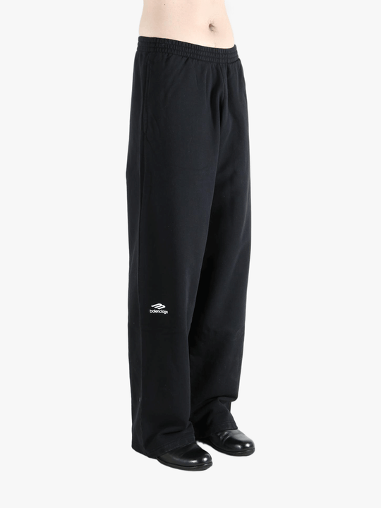 Black pants worn by a person, showing the pants fit