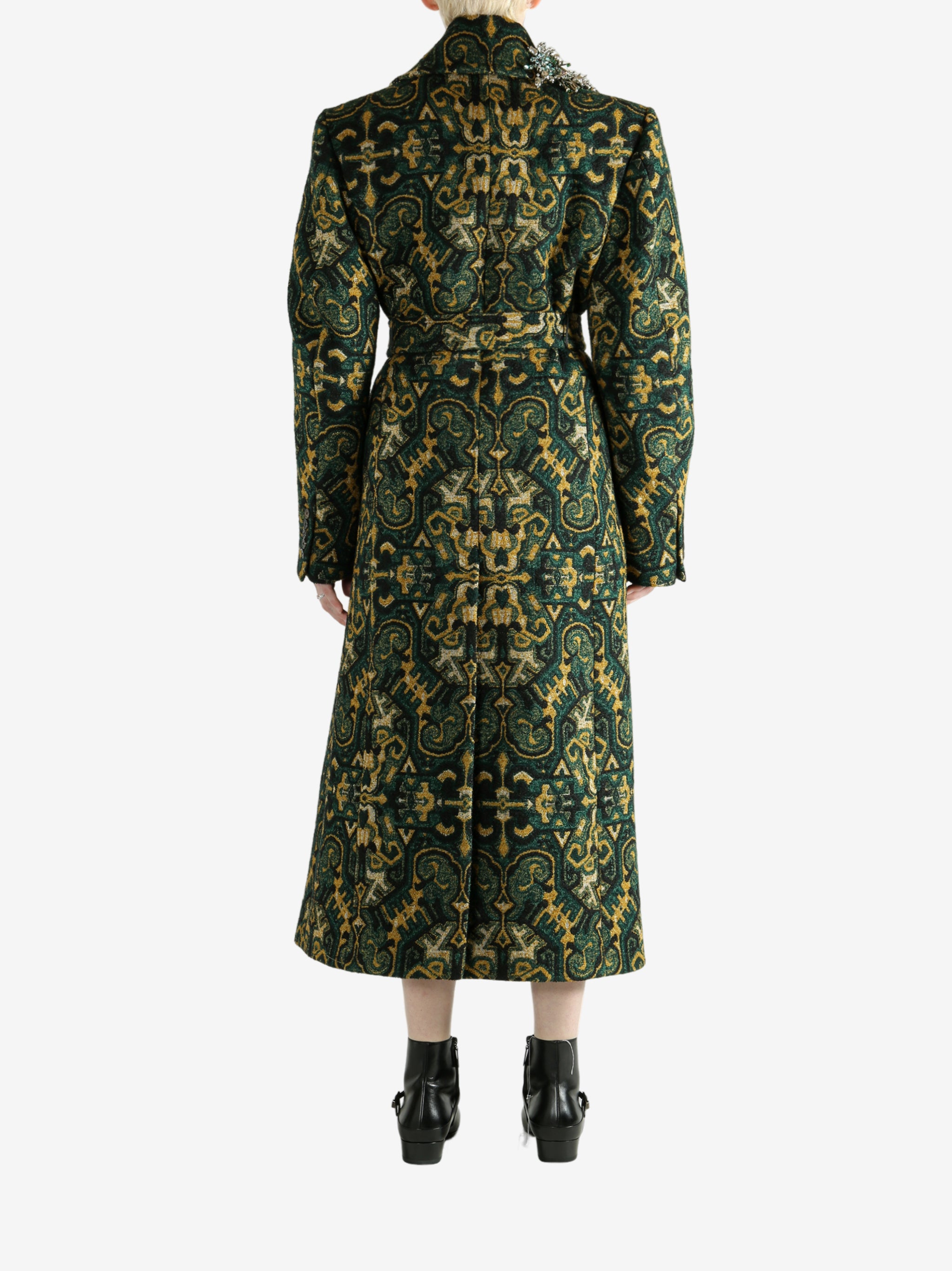 Green coat worn by a person, showing the coat's fit