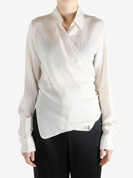 Tan shirt worn by a person, showing the shirt's fit
