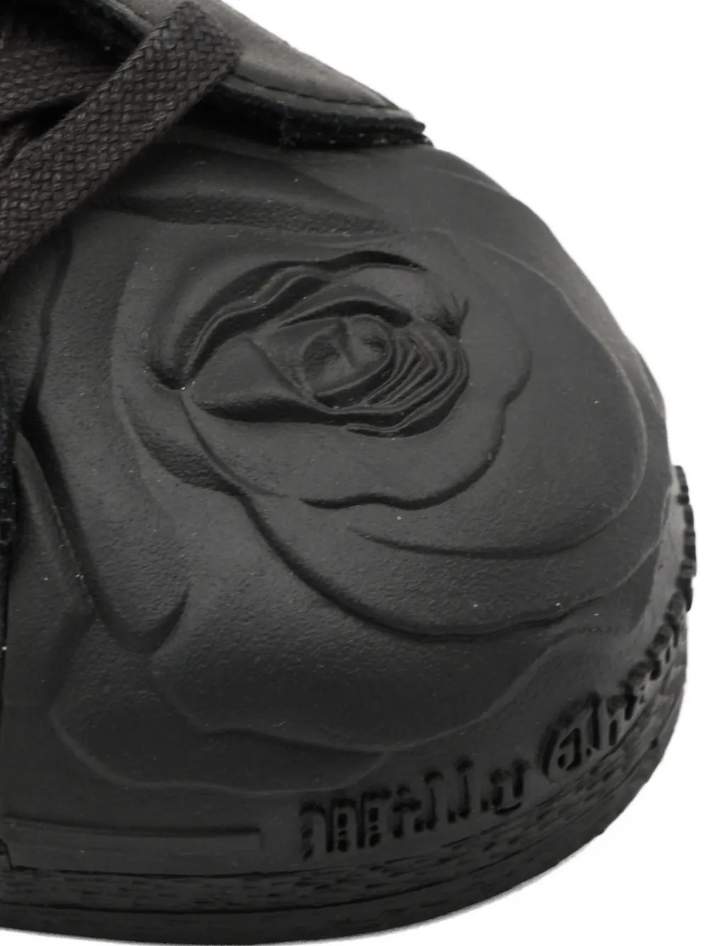 Close up of the black sneakers,showing texture of the blended fabric