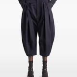 Navy pants worn by a person, showing the pants's fit