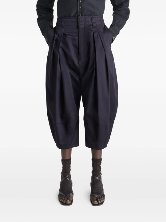 Navy pants worn by a person, showing the pants's fit