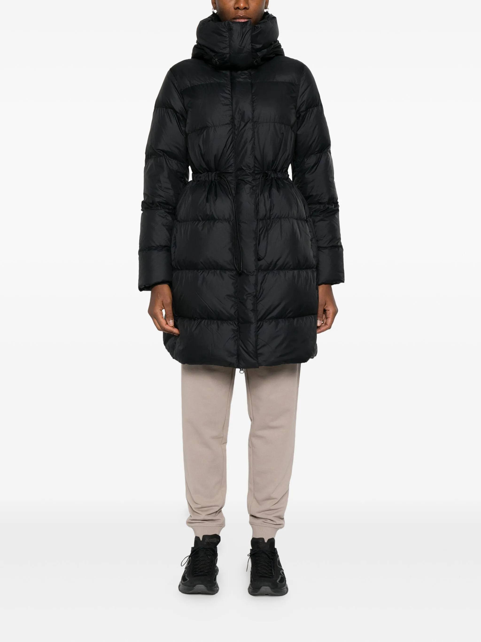 Black coat  worn by a person, showing the coat's fit