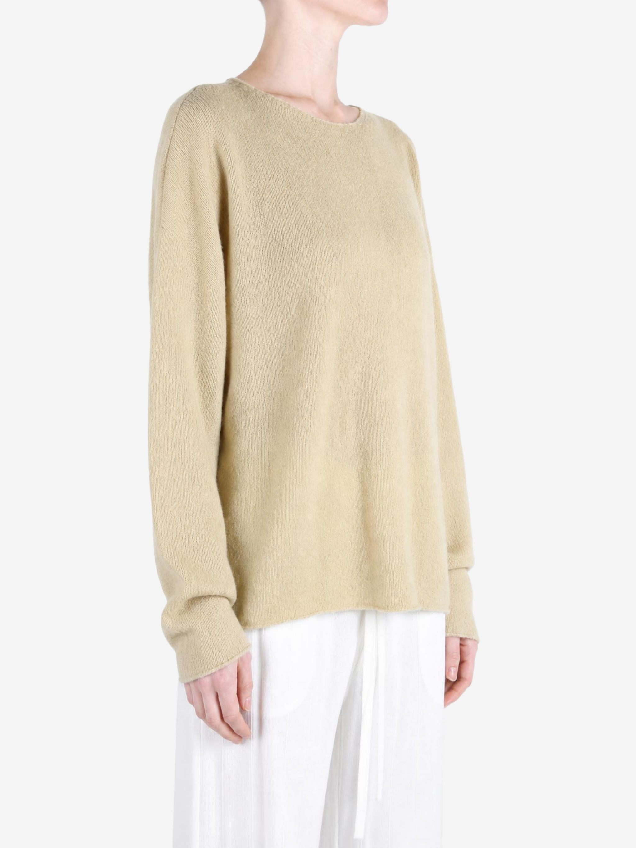 Tan knitwear worn by a person, showing the knitwear fit
