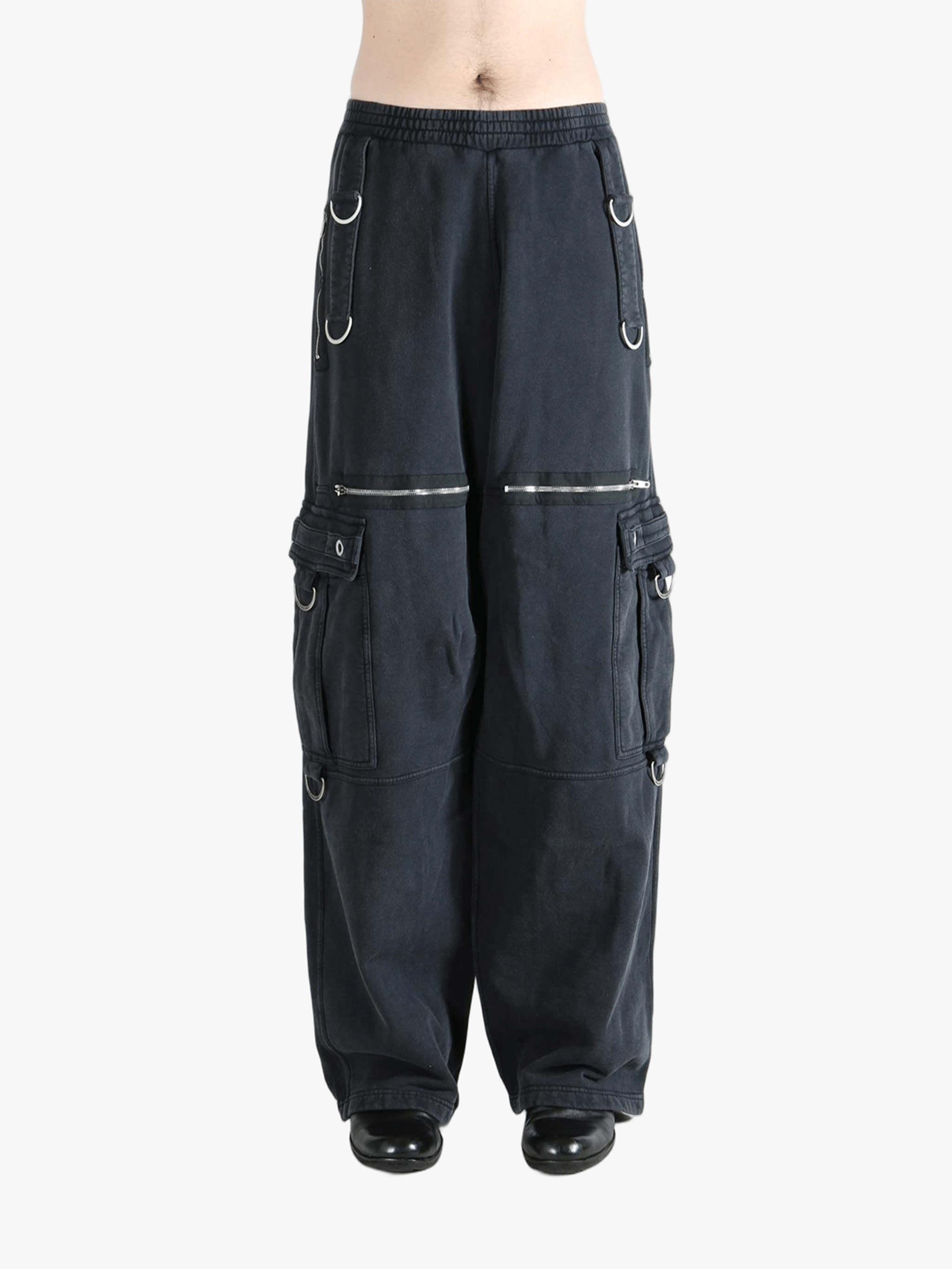 Black pants worn by a person, showing the pants' fit