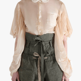 Tan shirt worn by a person, showing the shirt's fit