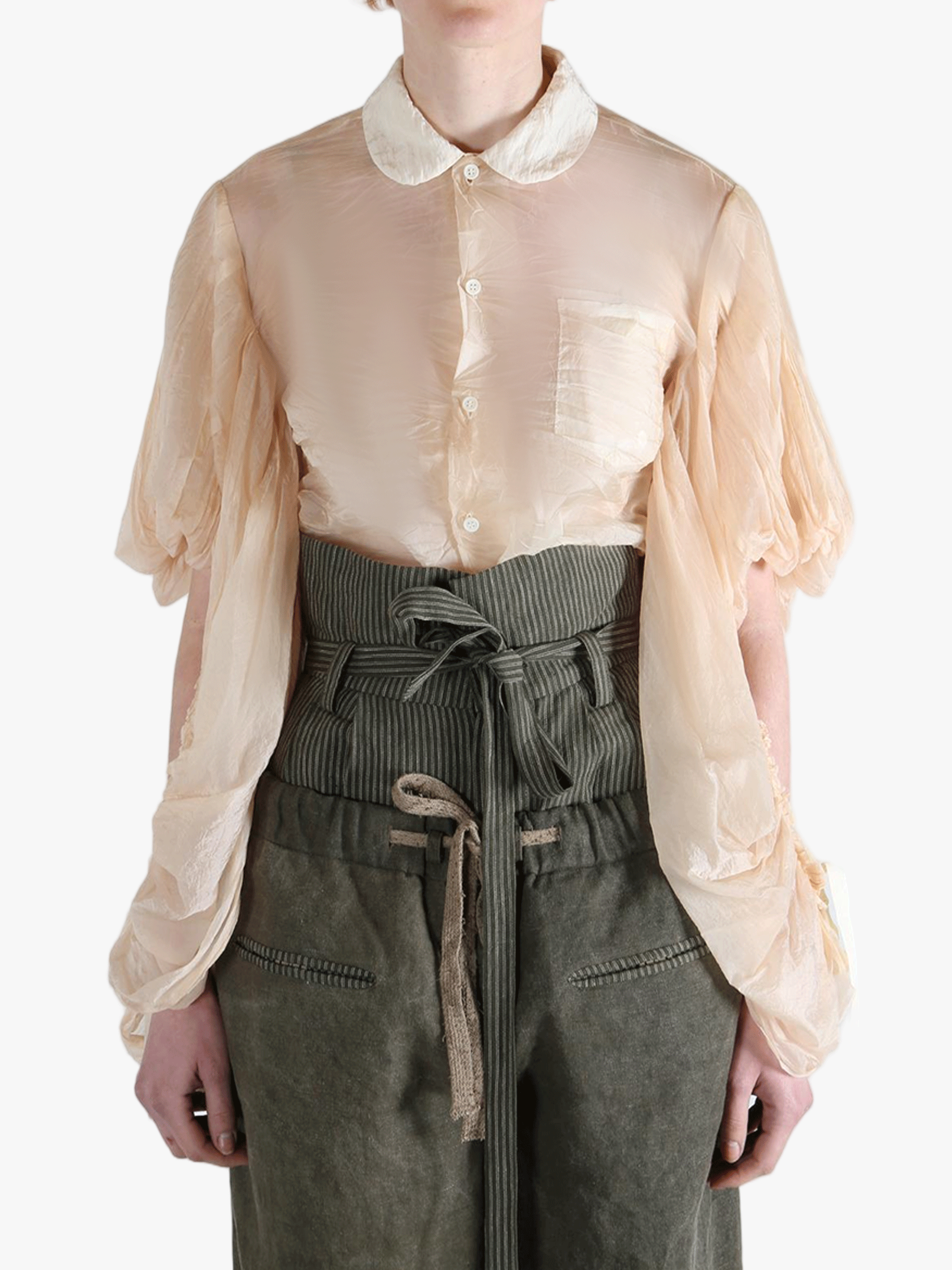 Tan shirt worn by a person, showing the shirt's fit