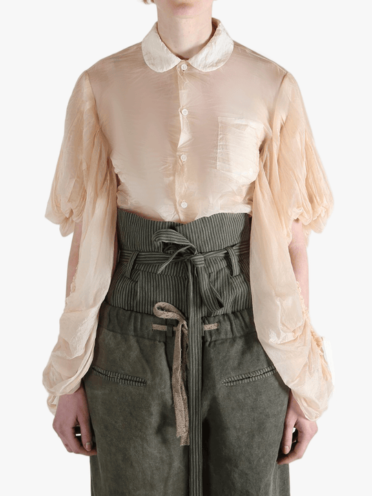 Tan shirt worn by a person, showing the shirt's fit