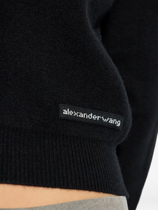 Close up of black knitwear, showing texture of the wool fabric