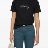 Close up of black t-shirts, showing texture of the cotton fabric