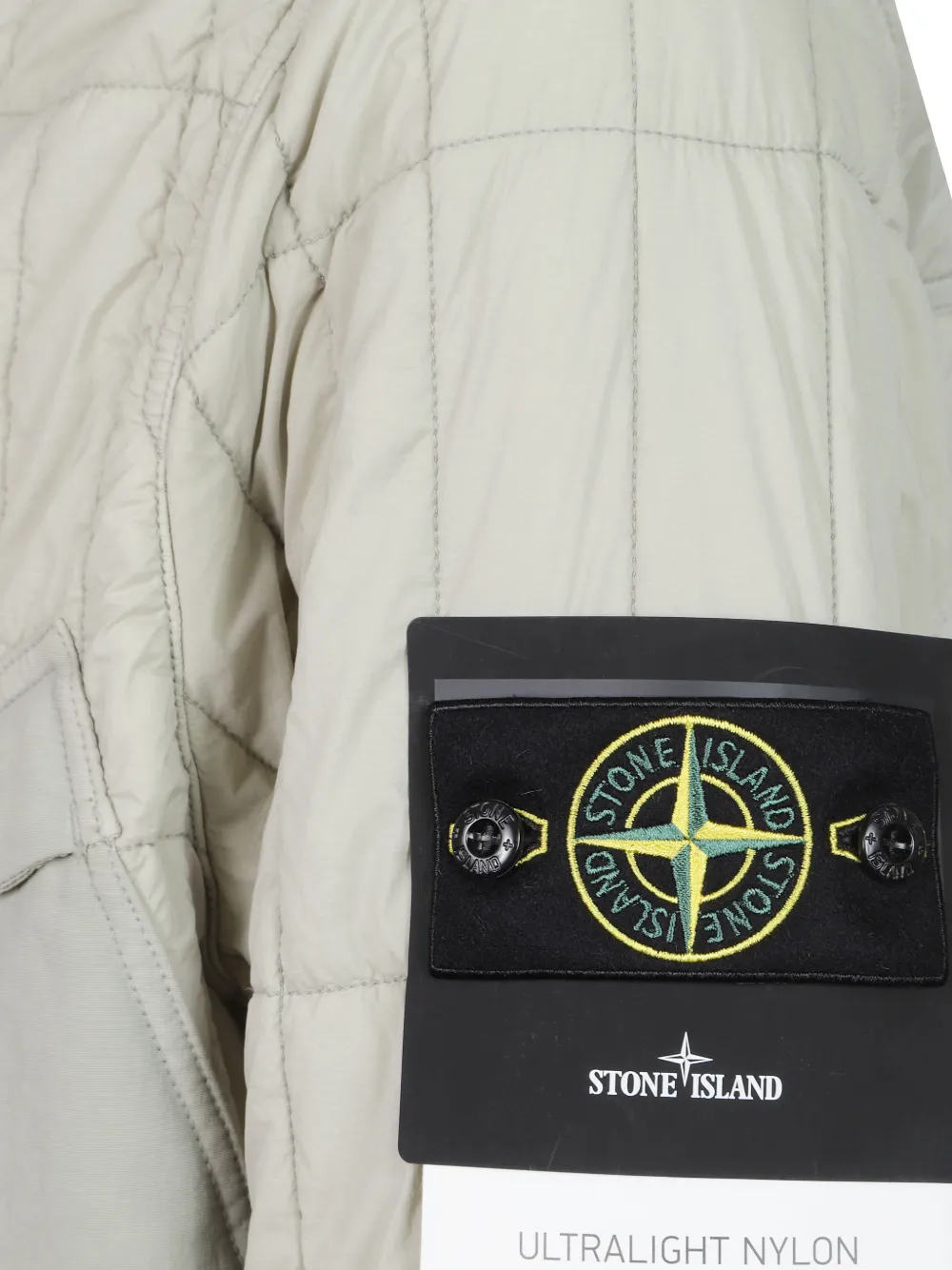 Close up of Tan jacket, showing texture of the 85% polyamide/ 15% elastane fabric