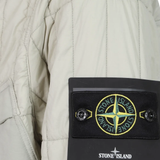 Close up of Tan jacket, showing texture of the 85% polyamide/ 15% elastane fabric