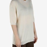 White top worn by a person, showing the top's fit