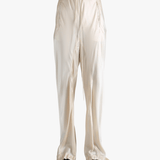 White pants worn by a person, showing the pant's fit