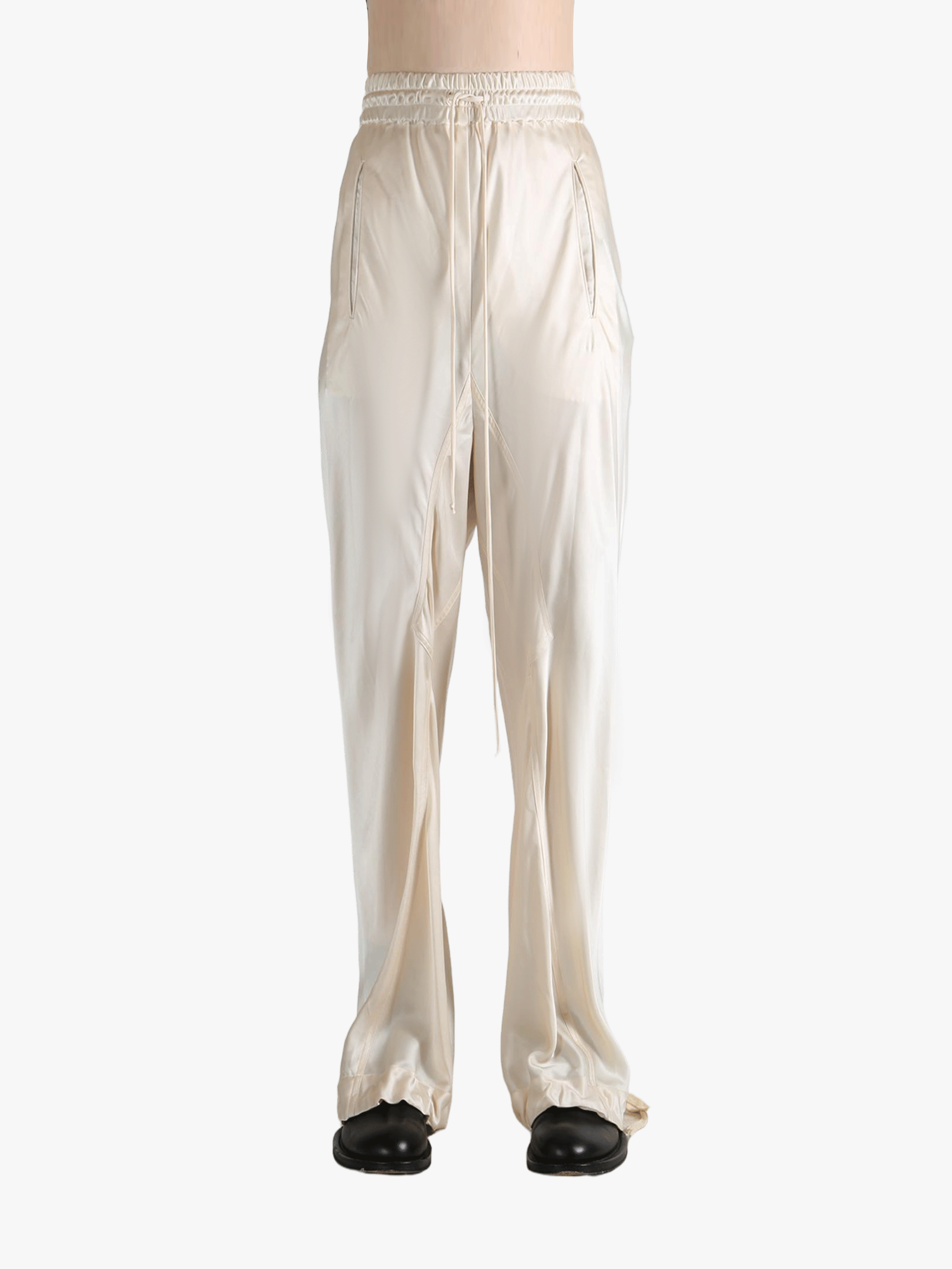 White pants worn by a person, showing the pant's fit