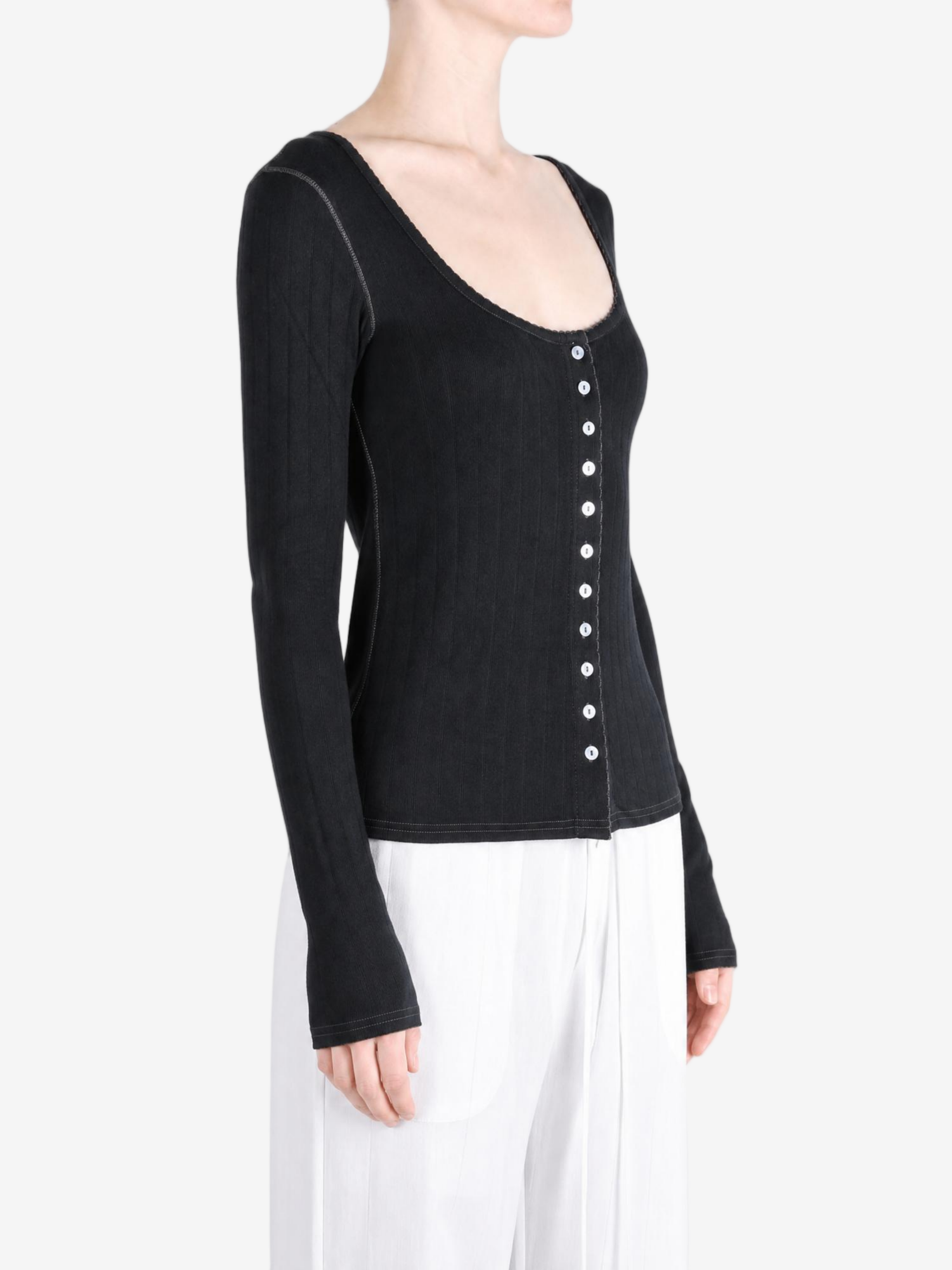 Black knitwear worn by a person, showing the knitwear fit