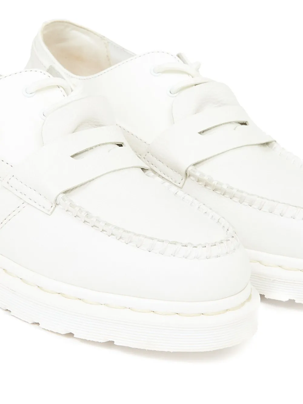 Close up of white boots,showing texture of the calf leather fabric.