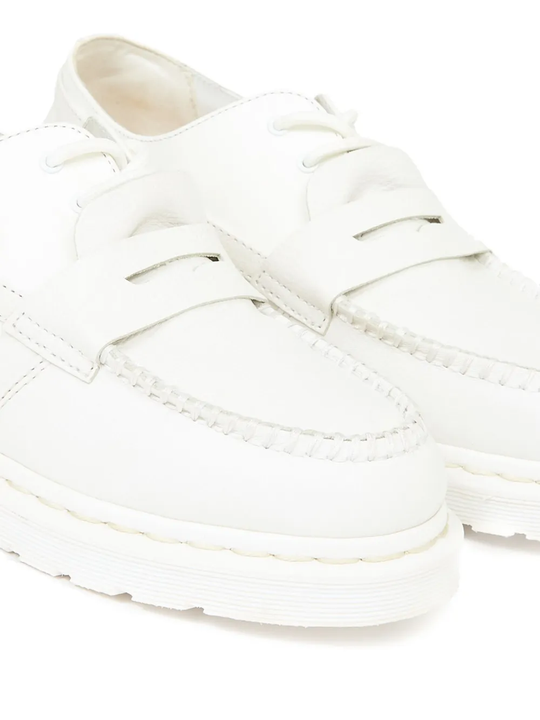 Close up of white boots,showing texture of the calf leather fabric.