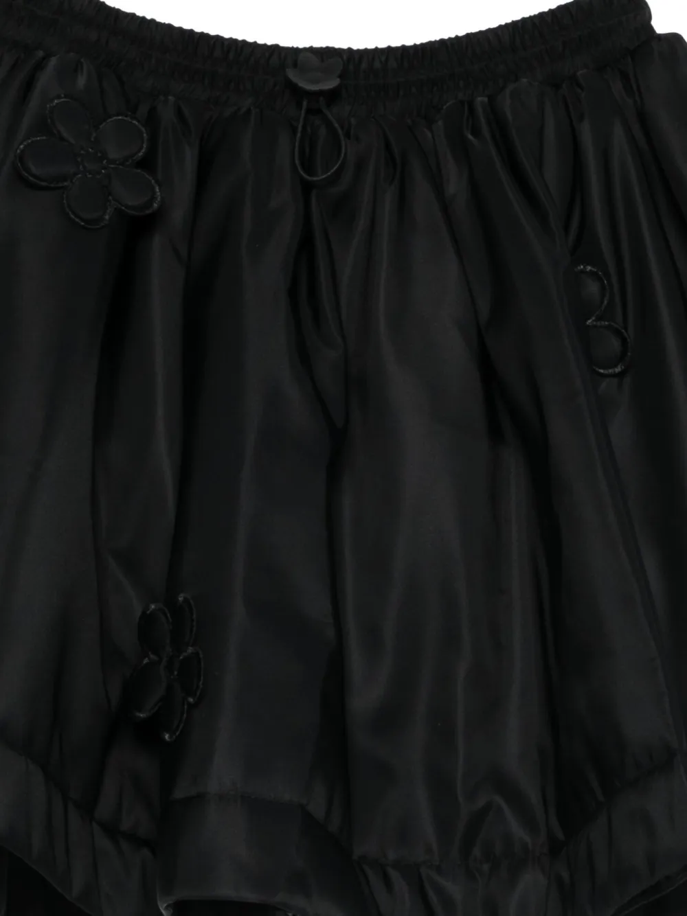 Close up of black skirts, showing texture of the viscose and polyester and      recycled polyamide fabric