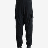 Black pants worn by a person, showing the pants' fit