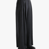 Black pants worn by a person, showing the pants fit
