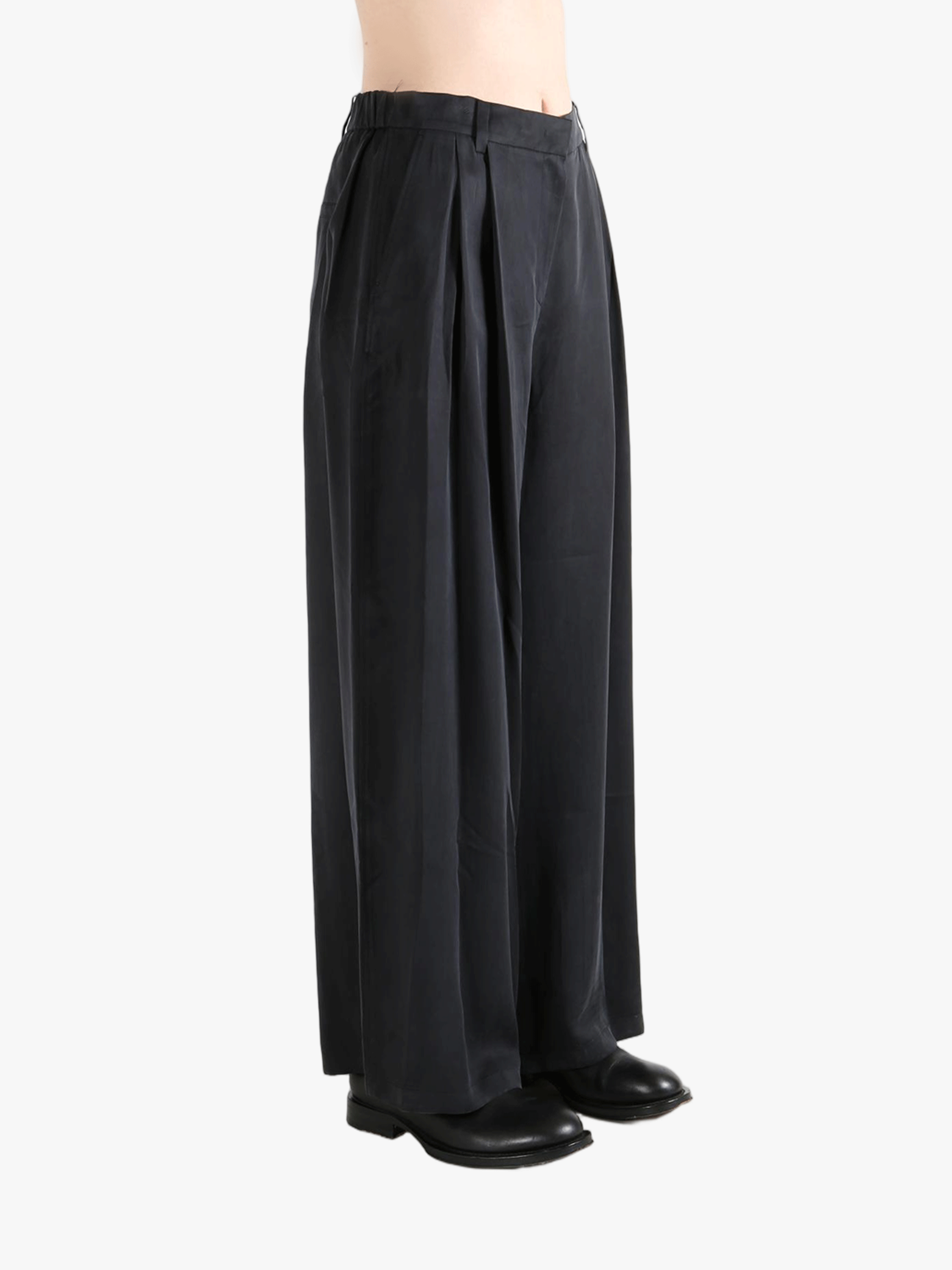 Black pants worn by a person, showing the pants fit