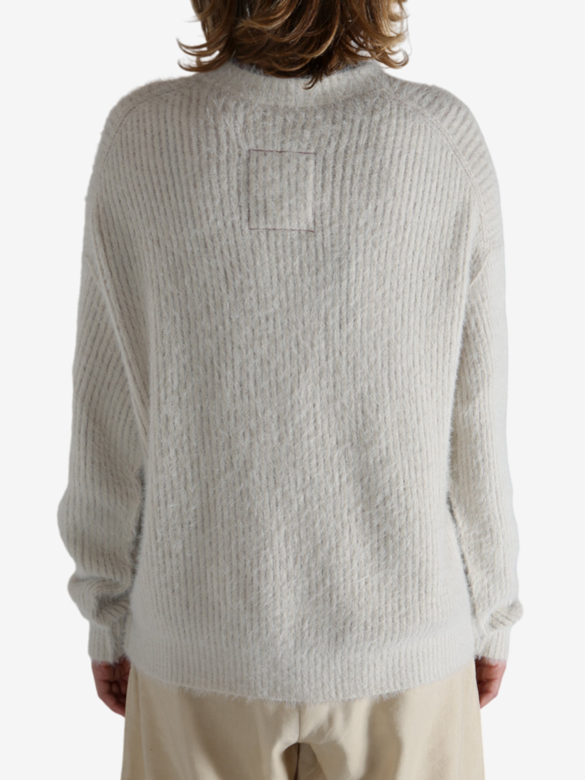 White top worn by a person, showing the top fit