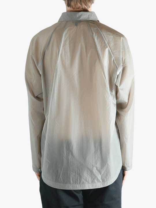 Grey shirt worn by a person, showing the shirt's fit