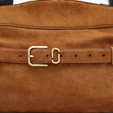 Close up of the brown bag, showing texture of the leather fabric