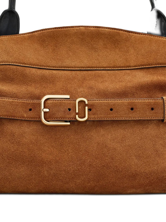 Close up of the brown bag, showing texture of the leather fabric
