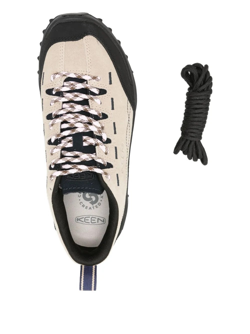 Close up of tan sneakers, showing texture of the leather and rubber fabric