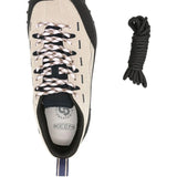 Close up of tan sneakers, showing texture of the leather and rubber fabric