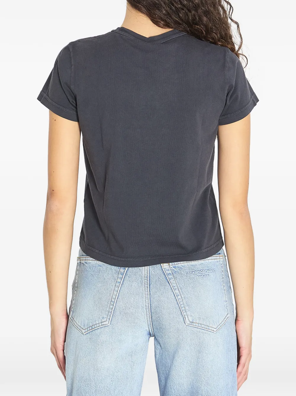 black t-shirt worn by a person, showing the t-shirt fit